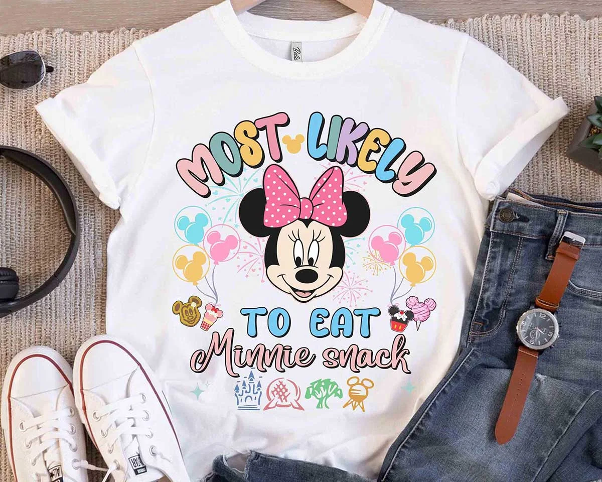 Personalized Disney Trip Most Likely To Family Vacation Tees 5 White Minnie Mouse Most Likely To Eat Minnie Snack Disney park vacation t-shirt flat lay with denim and headphones