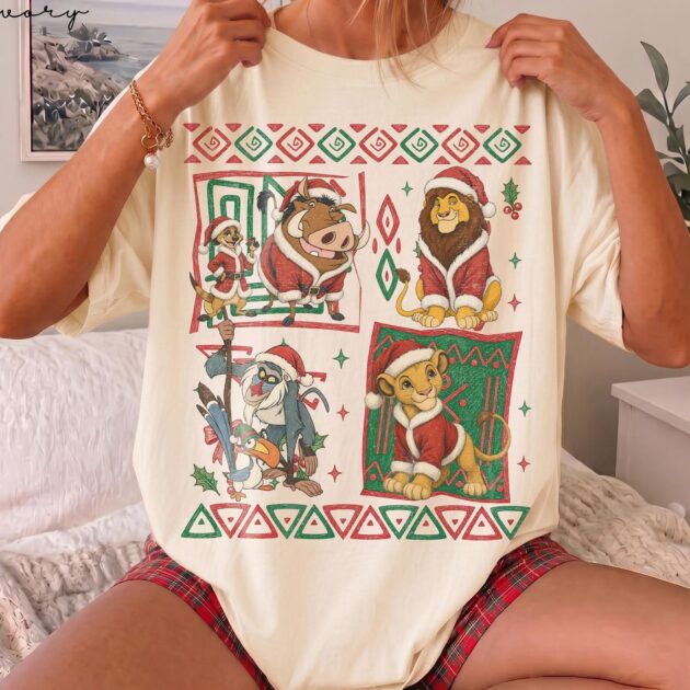 retro 90s lion king christmas shirt in ivory flat lay showing 4 aztec comic panels with santa simba timon and mufasa for 2027 disney trips