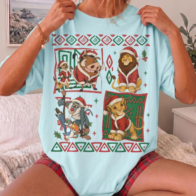 retro 90s lion king christmas shirt in chambray blue showing colorful aztec border comic panels with simba and pumbaa