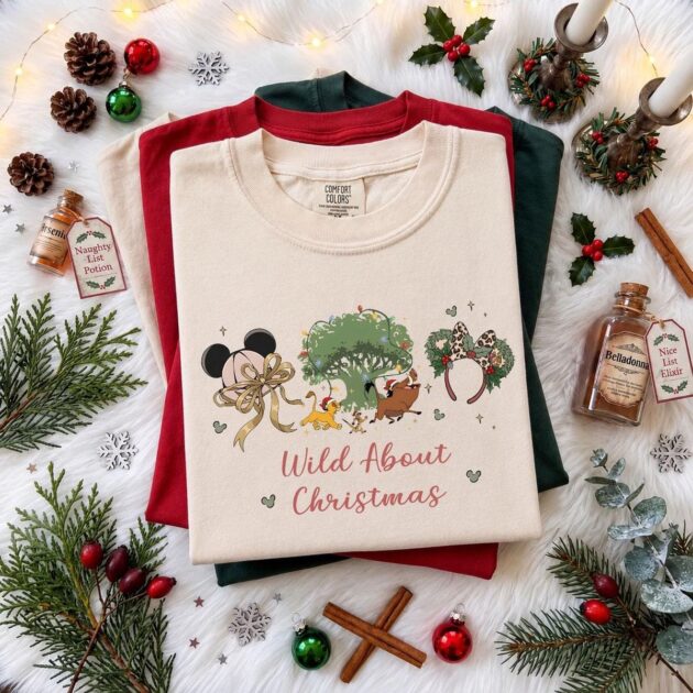 wild about christmas animal kingdom shirt in ivory flat lay with lit tree of life and leopard bow for 2027 holiday trips