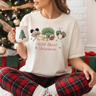 wild about christmas animal kingdom shirt in ivory worn with plaid pants near christmas tree for family holiday portraits