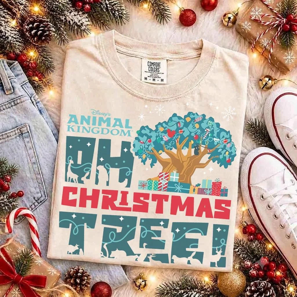 Animal Kingdom Oh Christmas Tree Shirt for Holiday Vacations 1 Flat lay of animal kingdom oh christmas tree shirt in sand cotton with holiday pine garland and vintage sneakers