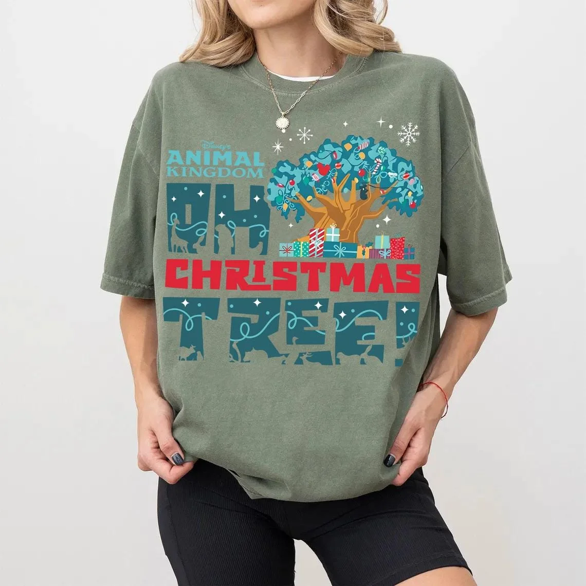 Animal Kingdom Oh Christmas Tree Shirt for Holiday Vacations 7 Woman wearing butter yellow decorated tree of life tee by stone fireplace with Christmas stockings