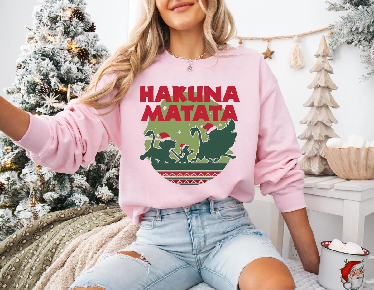 Lion King Hakuna Matata Christmas Sweatshirt with Nordic Art 1 Female model in decorated holiday room wearing soft light pink winter safari fleece sweatshirt