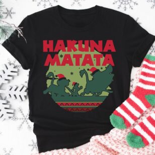 Lion King Hakuna Matata Christmas Sweatshirt with Nordic Art 10 Flat lay of black lion king hakuna matata t-shirt on white wooden planks with pine cones and holiday greenery