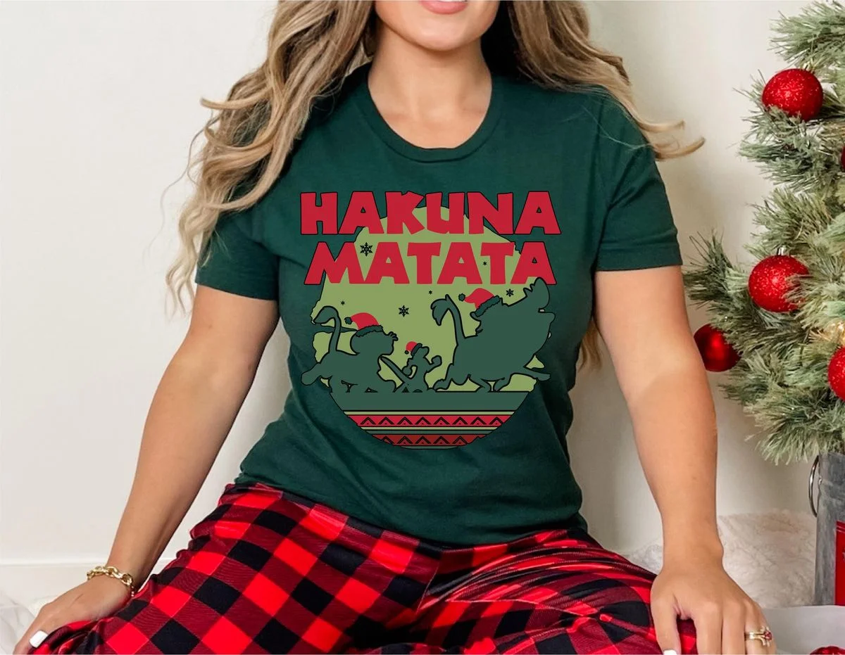 Lion King Hakuna Matata Christmas Sweatshirt with Nordic Art 2 Woman wearing dark forest green short-sleeve t-shirt with Santa Simba Timon and Pumbaa silhouette design