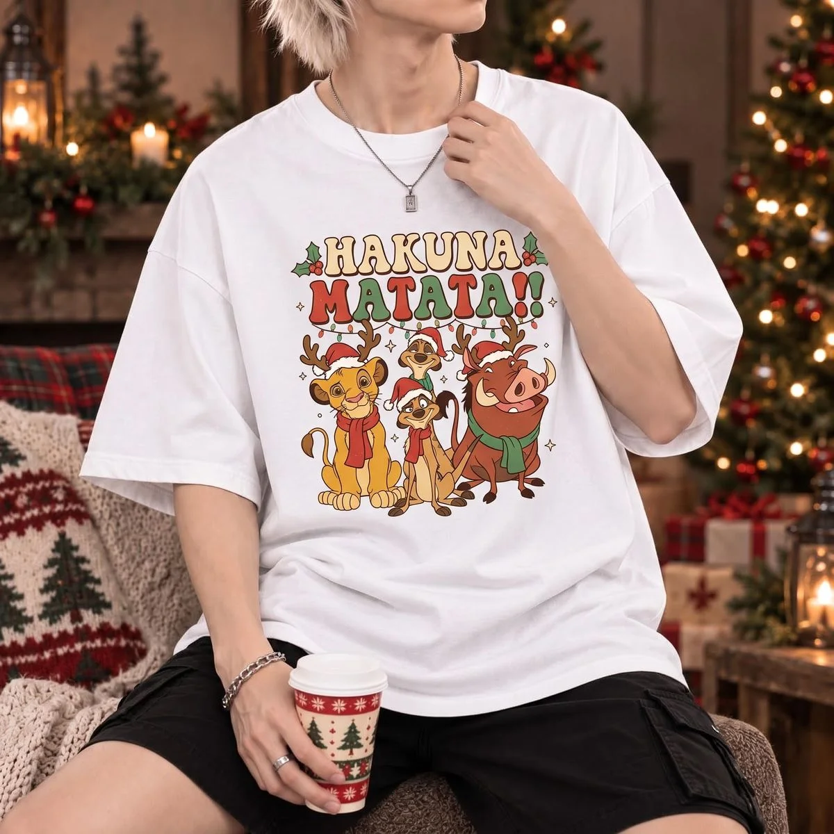 Lion King Teacher Christmas Shirt for Holiday Classroom Fun 3 Young man standing beside lit Christmas tree wearing white festive classroom simba tee with retro bubble lettering graphic
