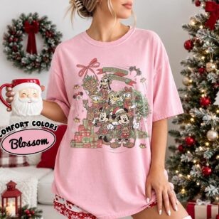 Vintage Wild About Christmas Safari Shirt Iconic Plaid Squad, Comfort Colors Disney Holiday Shirt 20 plaid safari gang tee in Comfort Colors blossom pink worn by woman holding Santa mug