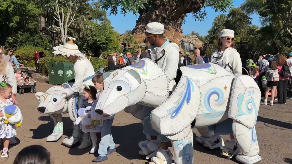 Christmas at Animal Kingdom Secrets Every Traveler Needs for 2027 5 Artisan sculpted white polar bear puppets and puppeteers interacting with children holding plush toys on Discovery Island