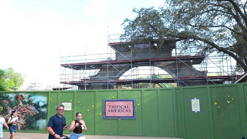 Christmas at Animal Kingdom Secrets Every Traveler Needs for 2027 13 Green construction walls with the Tropical Americas logo sign and massive archway scaffolding behind it at Disney's Animal Kingdom